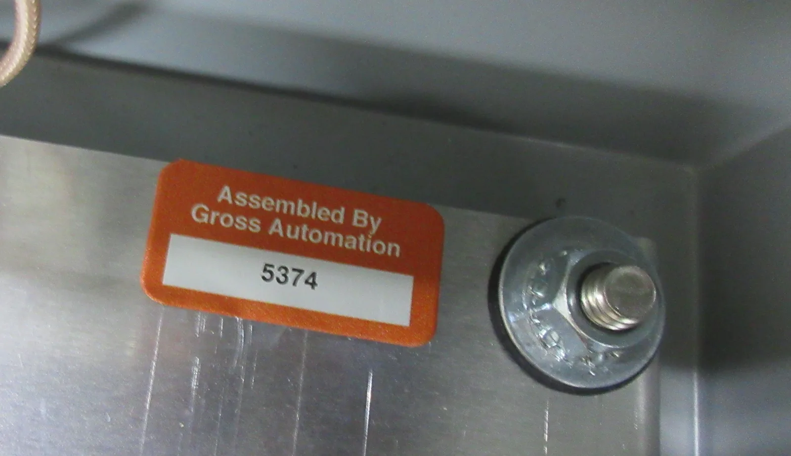 "Assembled by Gross Automation" build tag with serial number inside a stainless-steel cabinet