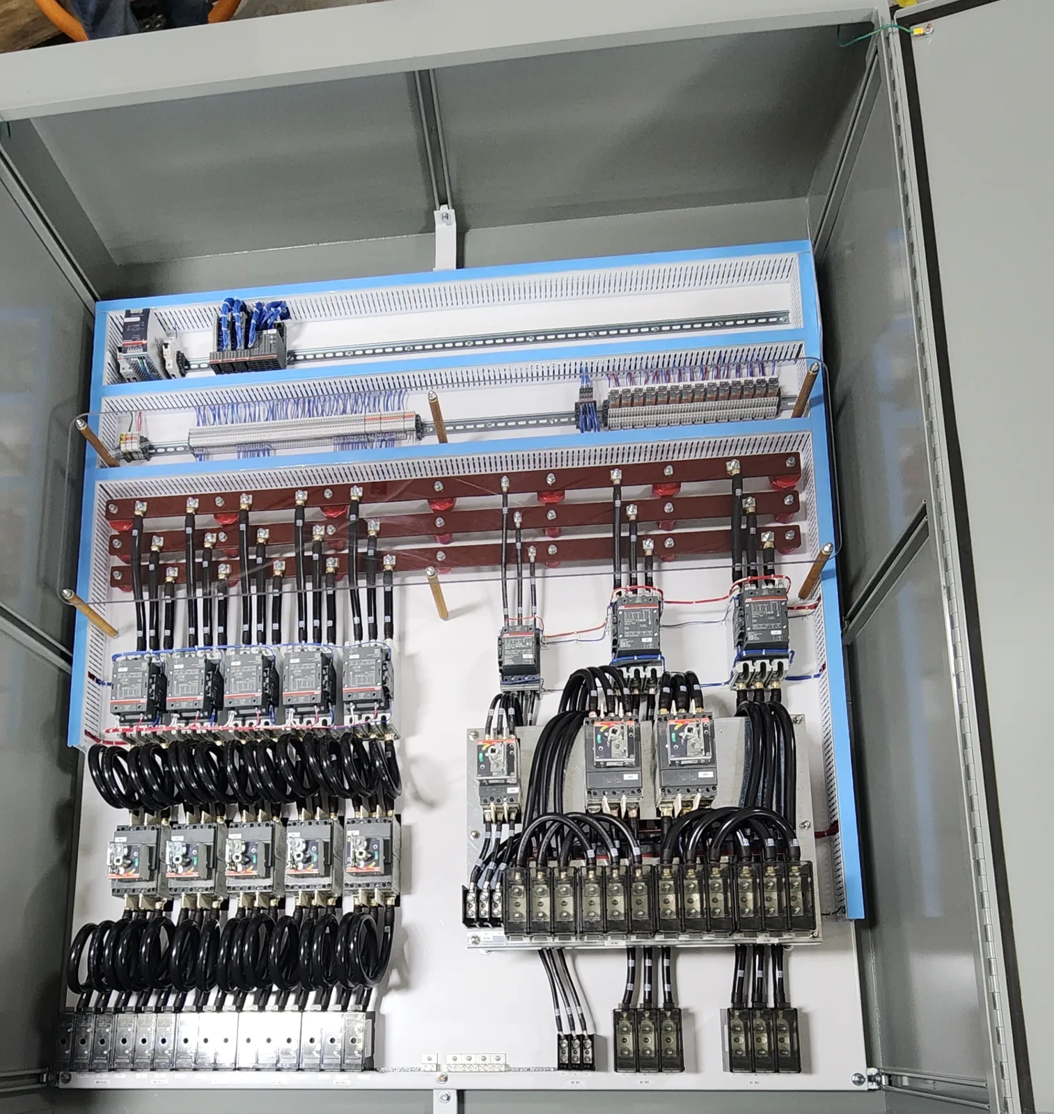Interior of a free-standing 690 V test panel: molded-case breakers, contactor banks and power distribution blocks, built in our UL 508A shop